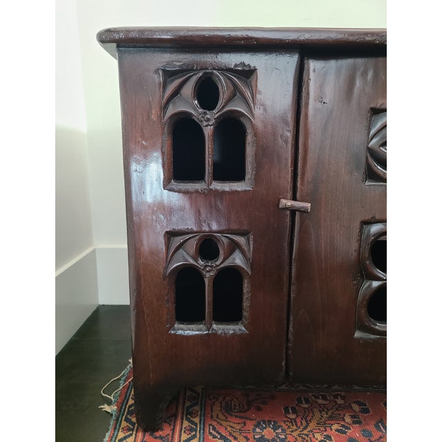 Late 20th century reproduction of a 15th century style gothic aumbry cupboard. Features an oversailing top above a single...