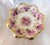 This is a small bowl of alternating dark and light pink flowers with hand painted white details plus gold glitter. The...