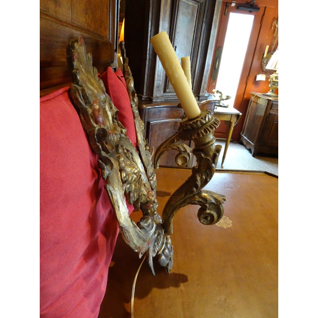 Pair of 19th Century Italian giltwood sconces. One arm. Us wired. Shell and acanthus leaf design. The whole sconce is...