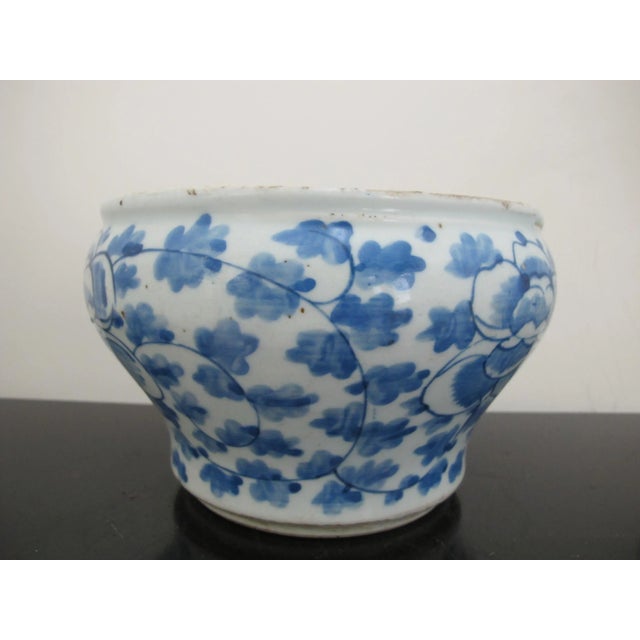 Antique, 19th century Chinese cache pot. White porcelain with blue scrolling peonies design. Good condition, showing some...