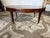 Vintage regency style Oval leather top flame mahogany coffee table on casters. by Weiman. It features an oval table top,...