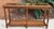 1970s Walnut two tier glass top console table cane shelf. Two removable beveled glass inserts with a cane shelf. Table...