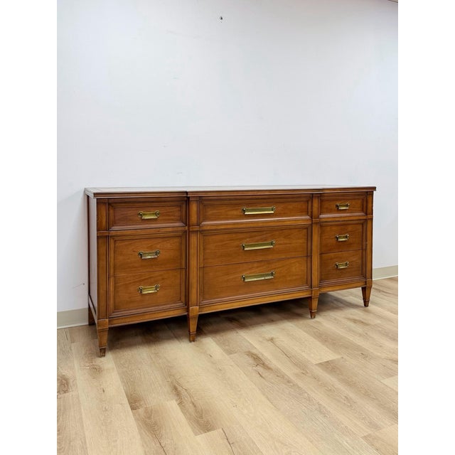 This handsome vintage Drexel transitional MCM nine drawer dresser is a beautifully crafted and highly collectible American...
