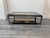 An exceptional tri-metal two tiered coffee table. Mirrored base with smoked glass top . C1970- Italy