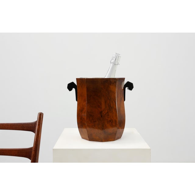 A refined and sculptural Art Deco ice bucket from France, dating to around 1925 and crafted in richly figured burlwood....