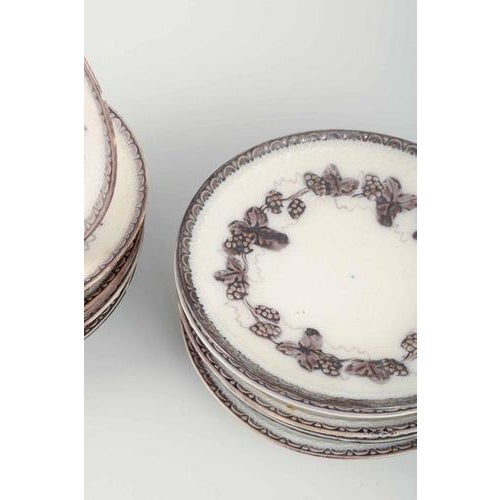 Gefle Plates “Mullbär”, 1930s Set of 12 round faience plates with relief decoration and grapevine motif in a brownish tone...