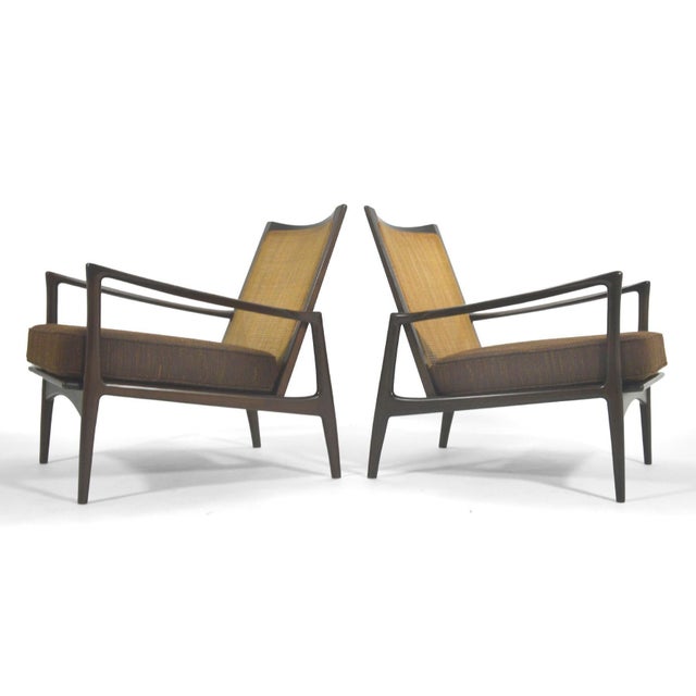 These two beautiful lounge chairs designed by Ib Kofod-Larsen for Selig have beautiful lines, cane backs, and new seat...