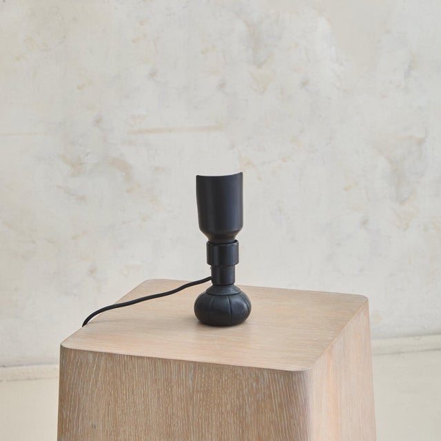 A ‘600P’ table lamp designed by Gino Sarfatti for Arteluce in 1966. Petite in scale, the lamp features a black lacquered...