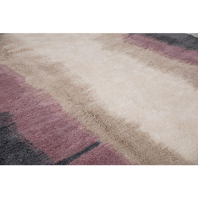 Artistic hand-knotted wool rug in Ivory, Rose, Sand, and Lavender, featuring a watercolor-inspired gradient design. The...