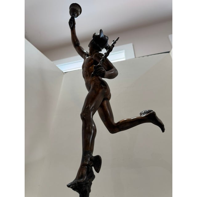 Tall patinated bronze figure of Mercury or Hermes after the famous model by Giambologna, shown in flight with a winged...
