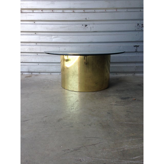 Vintage brass C. Jere brass drum coffee table that showcases a mid-century modern design. This antique coffee table...