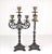 A vintage pair of three light decorative candelabras in the renaissance style. The black patination is over highly...