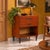 1960s cabinet characterized by a sleek and functional design typical of Italian craftsmanship of the era. The structure is...