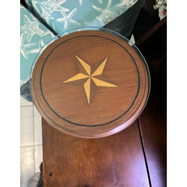 A beautifully crafted Colonial‑style mahogany stand featuring a round lift‑off top with an incised black circle and a...