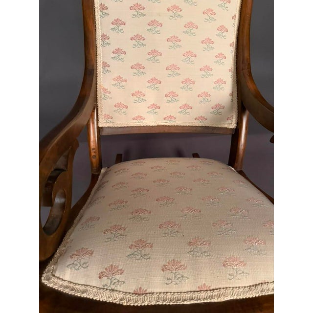 Late 19th-century American Victorian Lincoln rocking chair, circa 1890, crafted in walnut-stained birch. This beautifully...