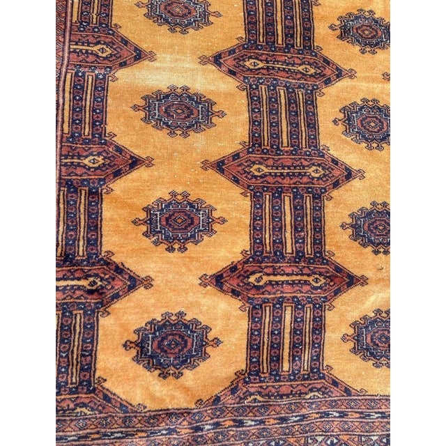 Nice Mid-Century Pakistani rug with a beautiful Bokhara design and nice colors with a yellow field, entirely and finely...