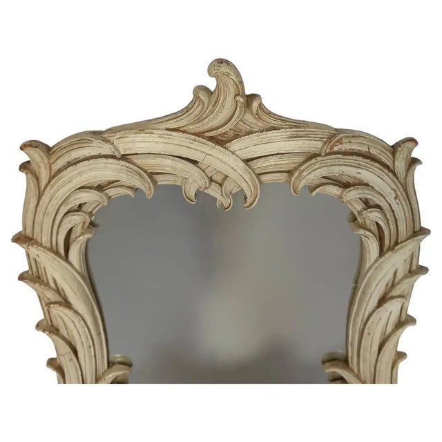 A glamorous Hollywood Regency Serge Roche–style palm leaf wall mirror featuring dramatic, sculptural palm fronds carved in...