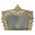 A glamorous Hollywood Regency Serge Roche–style palm leaf wall mirror featuring dramatic, sculptural palm fronds carved in...