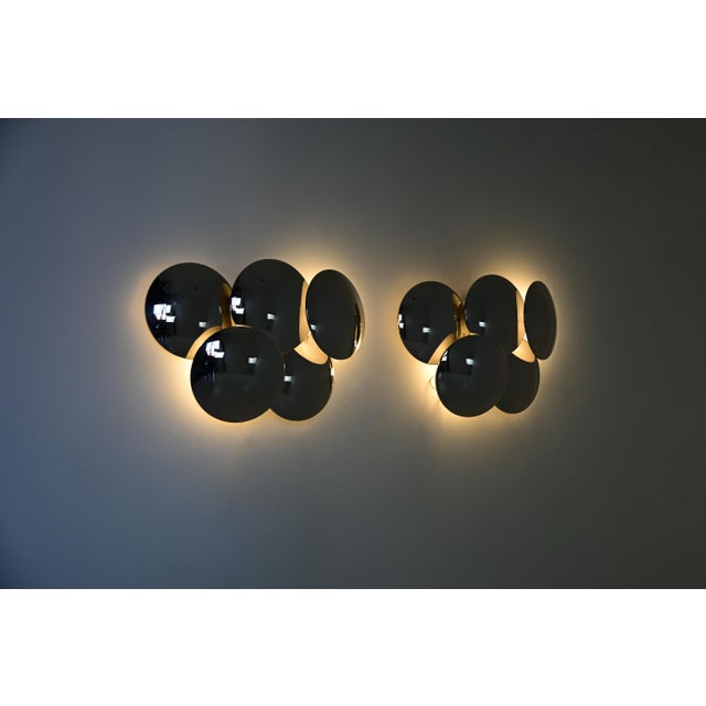 Pair of chromed metal wall lights designed by Goffredo Reggiani. Stamped Reggiani. Wear consistent with age and time. This...