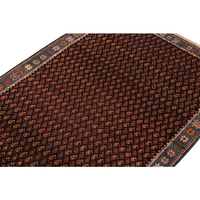 Hand-knotted in wool originating from Russia circa 1910-1920, this antique Russian rug connotes a transitional Kuba rug...