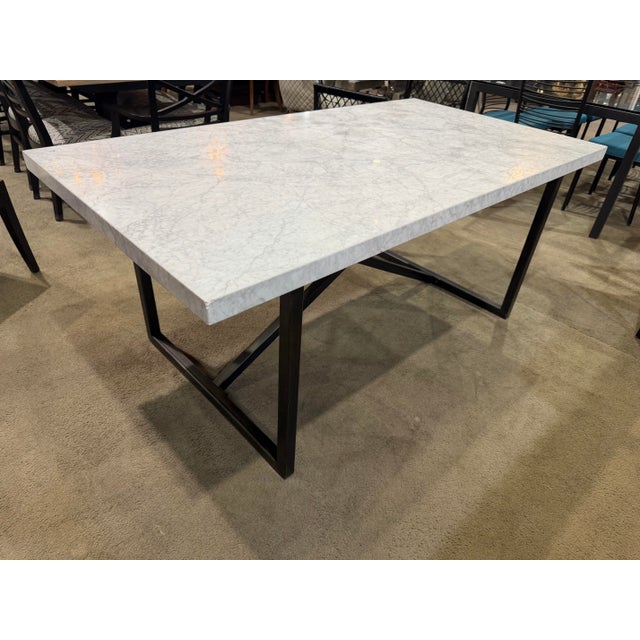 Striking in its simplicity, this Restoration Hardware Tarano dining table pairs the timeless beauty of a marble-inspired...