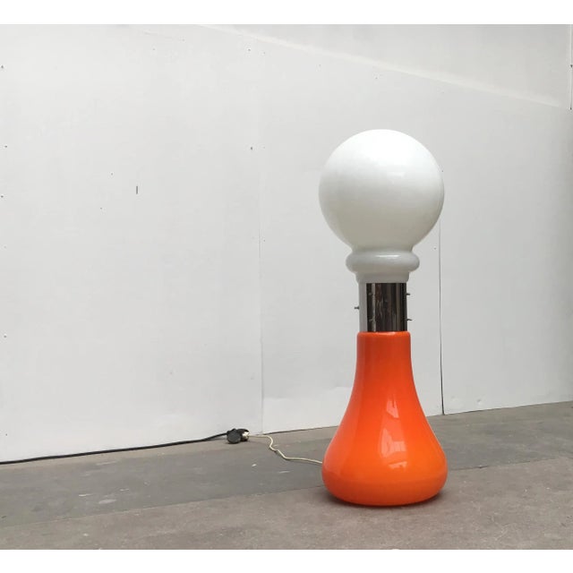 Stunning mid-century floor lamp with two glass shades in different colors. These floor lamps are generally attributed to...