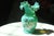 Beautiful teal Fenton Art glass bud vase with a ruffle edge with a painted gold rim. Hand painted with floral motifs on...