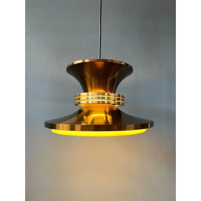 Vintage Danish pendant lamp in copper colour. The aluminium layered lamp creates a beautiful reflection of light. The lamp...