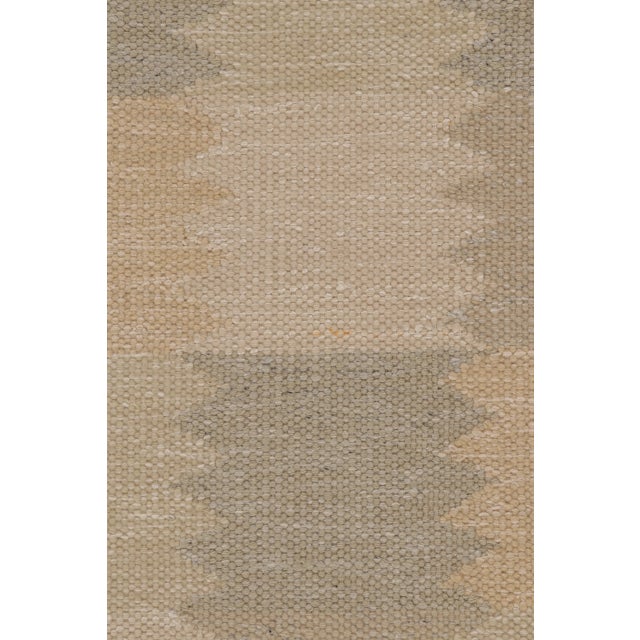 This 8x10 Scandinavian rug in wool and natural yarns presents a quiet geometric grid design in soft neutral tones,...