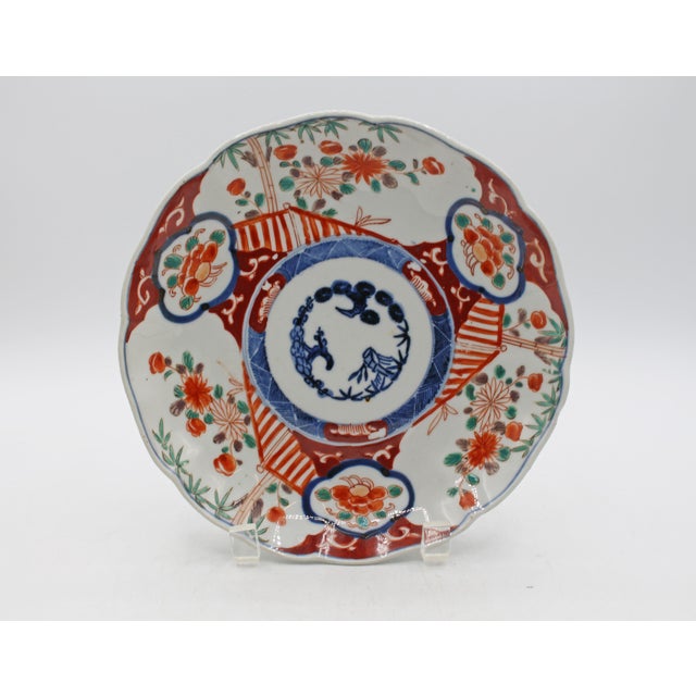 Circa 1880 shaped Imari plate, Japanese. Porcelain. Large reserves of chrysanthemums & bamboo with fence to protect the...