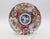 Circa 1880 shaped Imari plate, Japanese. Porcelain. Large reserves of chrysanthemums & bamboo with fence to protect the...