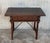About A Spanish walnut side table with single drawer, scalloped apron, carved legs and iron side stretcher from the late...