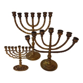 Mid-20th Century Trio Variegated Height Brass Menorahs For Sale