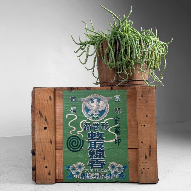 This wooden crate from Japan, produced by Dainippon Jochugiku Co., Ltd. (Kincho), was originally used for packaging...