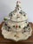 Large Italian hand-painted Majolica pottery tureen with ladle. Features florals in blue, yellow, and green. The lid has a...