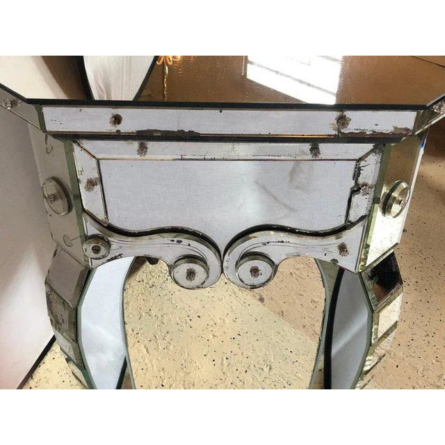 This one of a kind Hollywood Regency mirrored console with applied decoration and cabriolet legs is a must have in any...