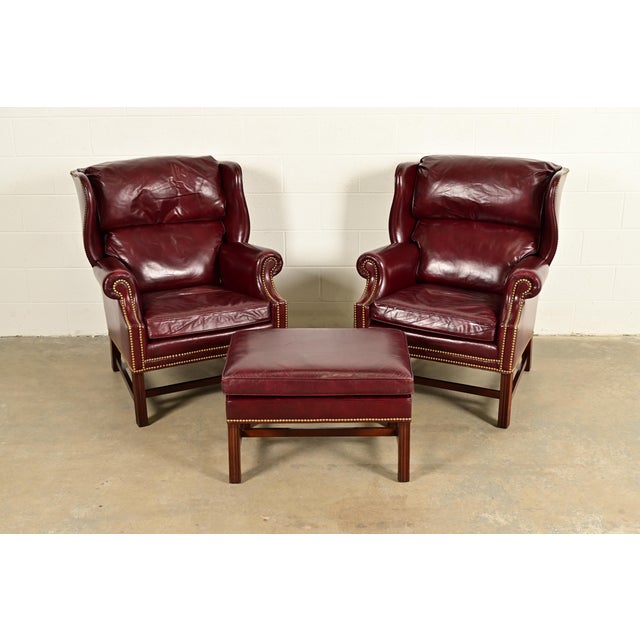 A gorgeous pair of Chippendale style wingback library chairs, lounge chairs, or fireside chairs with single ottoman By...