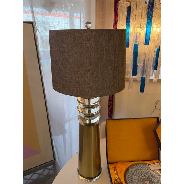 Tall impressive brass finish conical shape lamp. Fashioned of satin brass finish metal and stacked round lucite orbs....