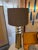 Tall impressive brass finish conical shape lamp. Fashioned of satin brass finish metal and stacked round lucite orbs....