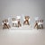 Set of four armchairs with sculptural solid walnut frames. The trapezoidal backrests transition elegantly into the seats,...