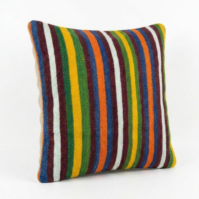 This beautiful 24'' x 24'' pillow cover was made from an authentic Turkish rug. Bright colors of wool adorn the front of...