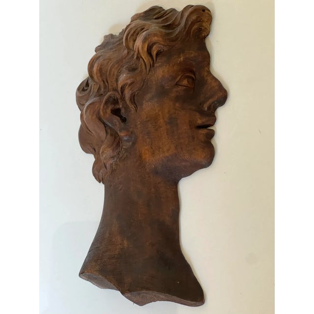 Hand carved dark walnut figure of a man's head, profile. Classic features and patina. This must have been salvaged from...