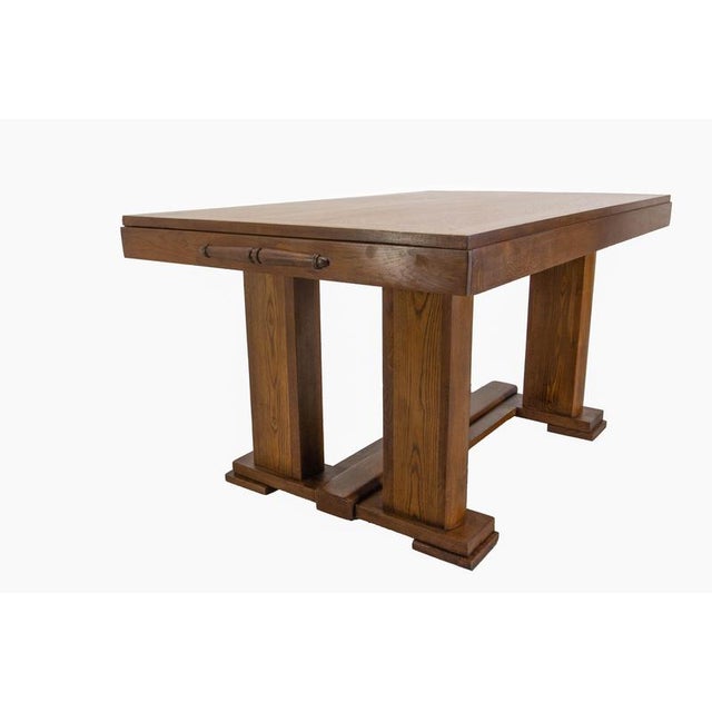 A French-style dining table dating from around 1940, crafted from oak. It is distinguished by its sturdy construction and...