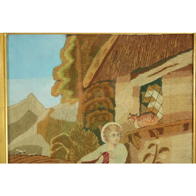 Victorian Woolwork picture of a child playing with a cat. Worked in wool and silk on linen and silk ground, in a variety...