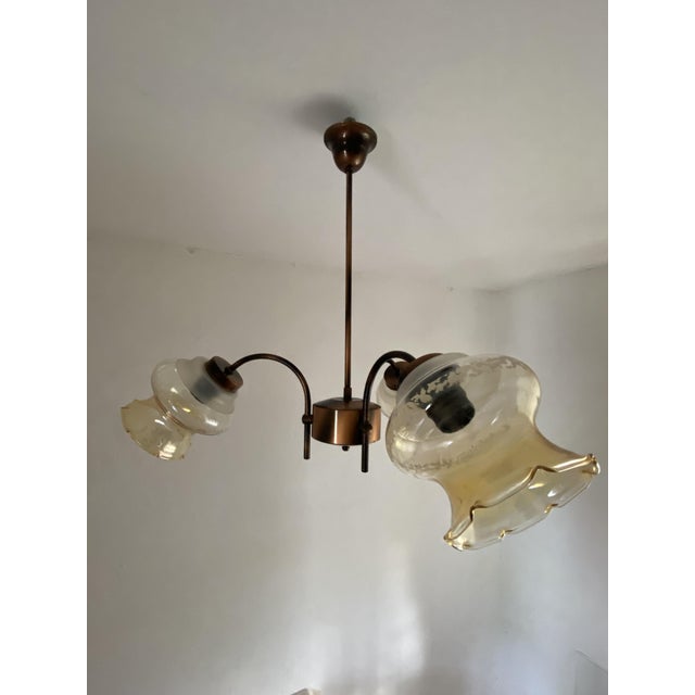 Vintage three-light chandelier manufactured by kaj d.o.o. In dol pri hrastniku, slovenia. The piece features an elegant...