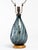 Blenko smoke blue glass lamp with circular wood base. Original hardware and finial. Overall height measures 27 inches,...