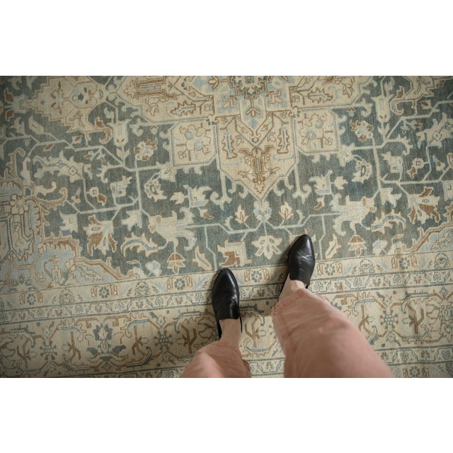 :: Oversize center medallion adorned by arrowed finials atop a covered field in a Heriz-like rendering of sprawling...