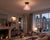 Elegant pendant light featuring a beautiful, sculptural mauve glass shade with deep vertical ribbing and a softly...