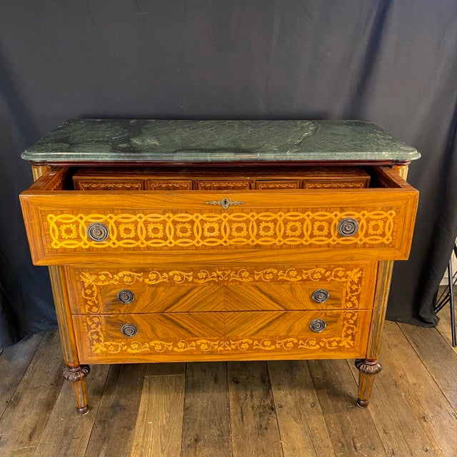Finely detailed with exquisite marquetry, this Italian commode secretary features a beautiful gray green marble top and...