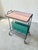 An elegant side table with a built-in magazine rack, designed in the mid-century modern style of the 1960s and 1970s. The...